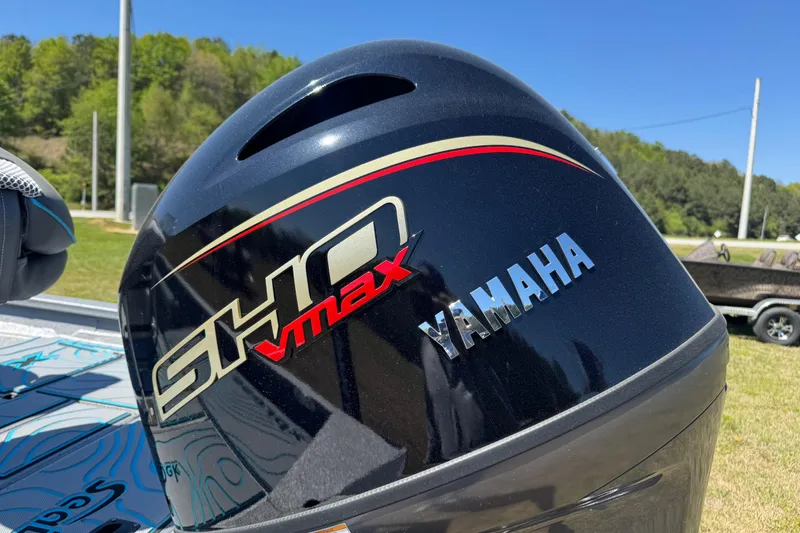 Slide: The Image of Yamaha SHO VMAX engine on 2025 Xpress H20B Bay boat, outdoors in sunny setting. - 10