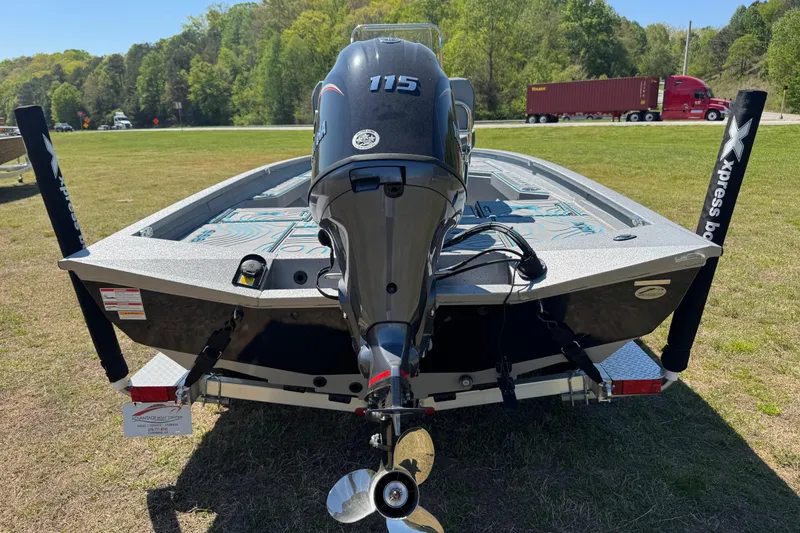 Slide: The Image of 2025 Xpress H20B Bay boat with Yamaha 115 engine, parked on grass. - 11