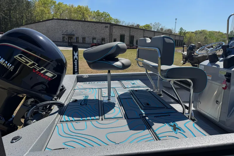 Slide: The Image of 2025 Xpress H20B Bay boat interior with Yamaha engine, featuring sleek seating and modern design. - 12