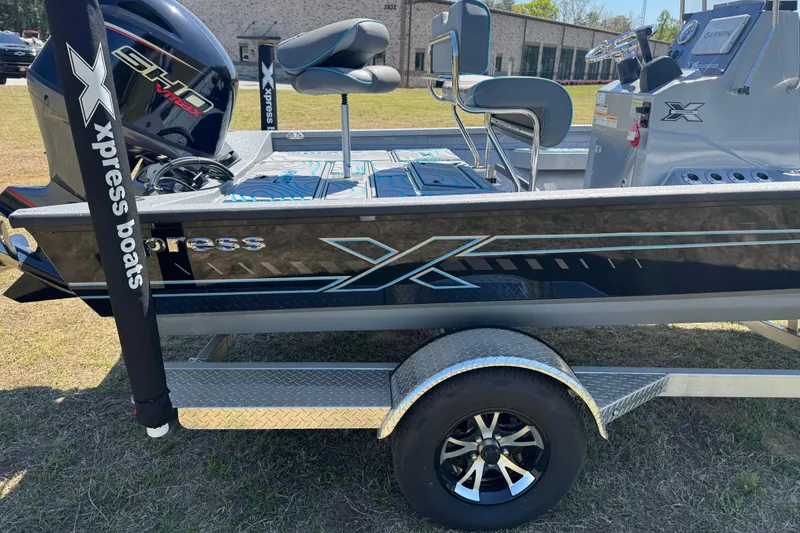 Slide: The Image of 2025 Xpress H20B Bay boat on trailer, featuring sleek design and modern seating. - 13