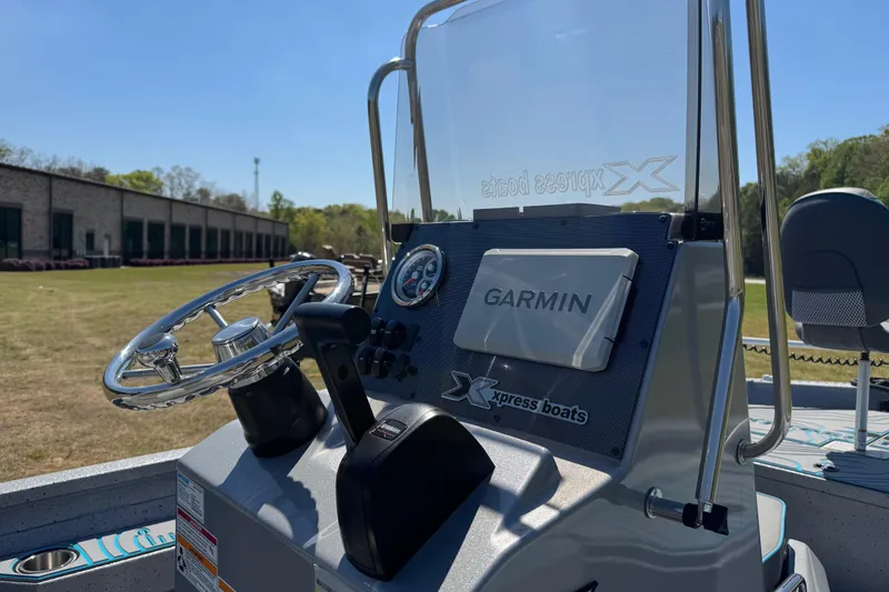 Slide: The Image of 2025 Xpress H20B Bay boat dashboard with Garmin navigation system. - 14