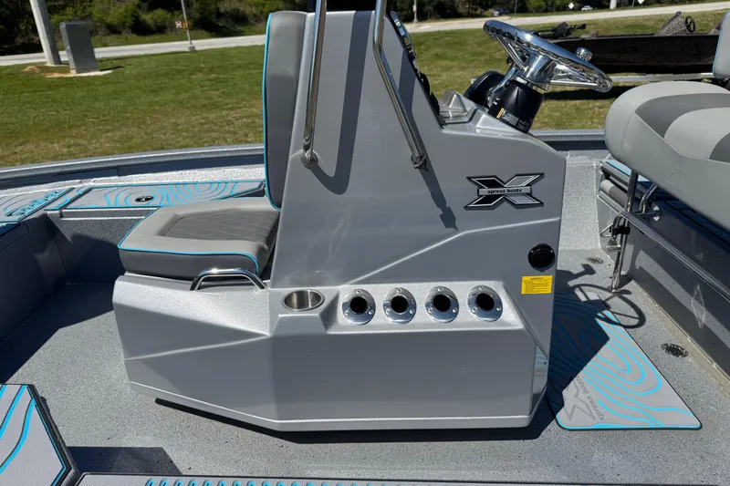 Slide: The Image of 2025 Xpress H20B Bay boat console with steering wheel and seating, featuring sleek design. - 7