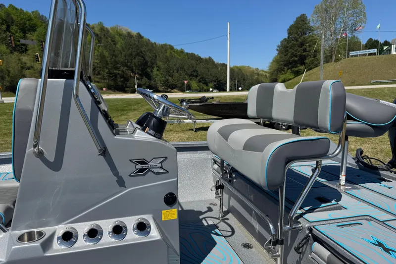 Slide: The Image of 2025 Xpress H20B Bay boat interior with seating and steering console. - 8