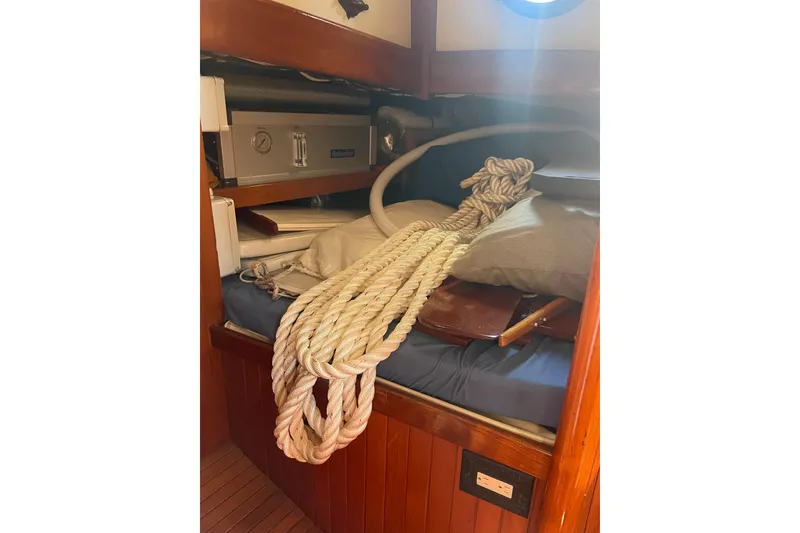 Slide: The Image of Cozy cabin interior of 1981 Hans Christian MKII sailboat with rope and storage. - 10