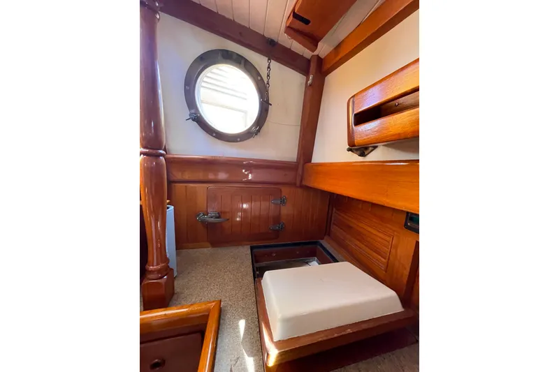 Slide: The Image of Interior of 1981 Hans Christian MKII sailboat with wooden finishes and porthole window. - 13