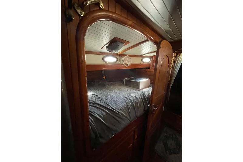 Slide: The Image of Cozy cabin interior of 1981 Hans Christian MKII sailboat with wooden finish and portholes. - 16
