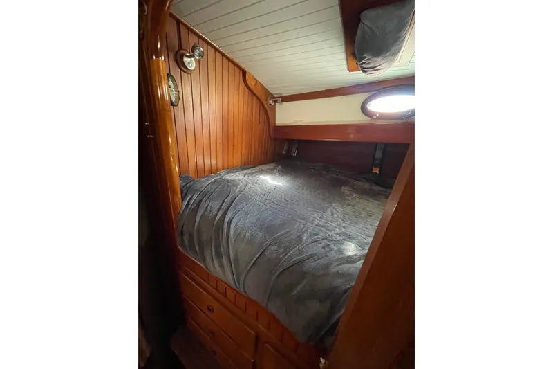 Slide: The Image of Cozy wooden cabin interior of 1981 Hans Christian MKII sailboat with bed and porthole. - 17