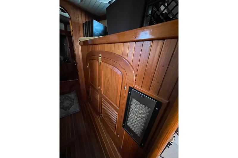 Slide: The Image of Wooden interior of 1981 Hans Christian MKII sailboat, featuring elegant cabinetry and paneling. - 18