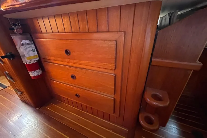 Slide: The Image of Wooden interior of 1981 Hans Christian MKII sailboat with drawers and fire extinguisher. - 19