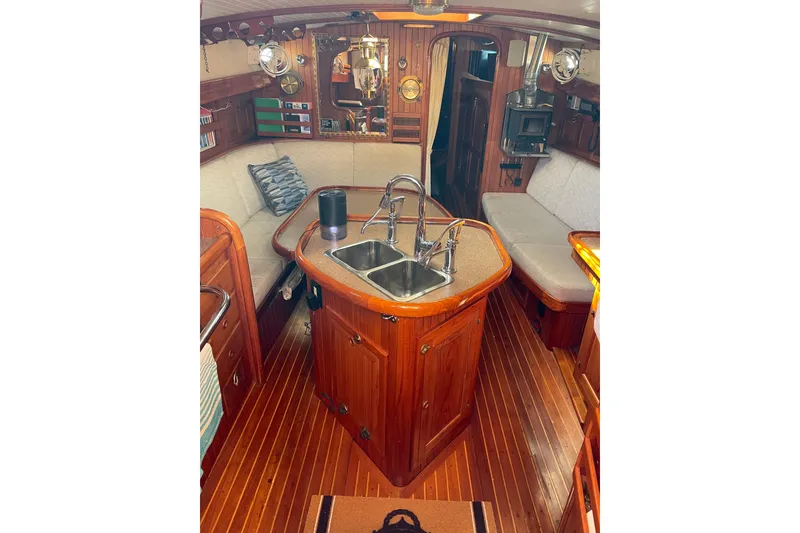 Slide: The Image of Interior of 1981 Hans Christian MKII sailboat with wooden finishes and cozy seating area. - 2