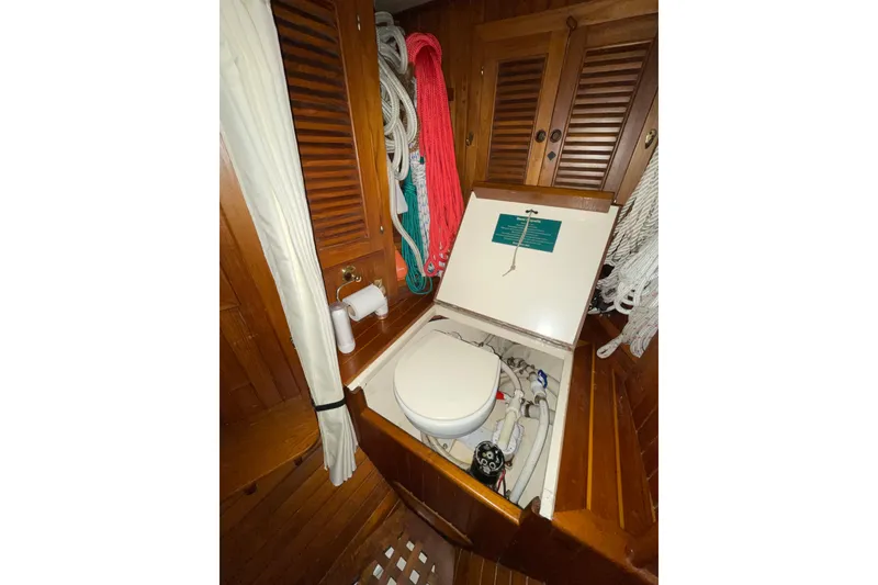Slide: The Image of 1981 Hans Christian MKII yacht bathroom with wooden cabinetry and marine toilet. - 22