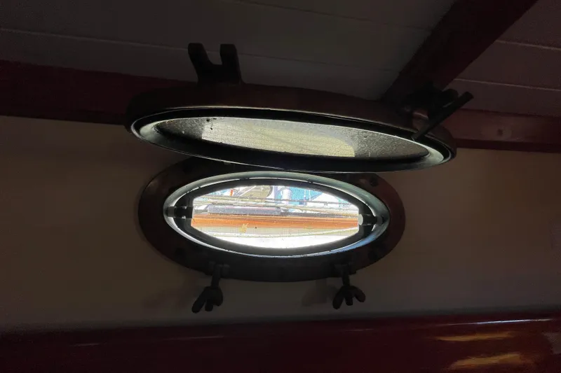 Slide: The Image of Open porthole on 1981 Hans Christian MKII sailboat, showcasing nautical interior details. - 26
