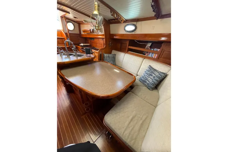 Slide: The Image of Interior of 1981 Hans Christian MKII sailboat with cozy seating and wooden finishes. - 3