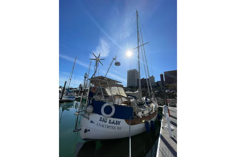 Slide: The Image of 1981 Hans Christian MKII sailboat docked under clear blue sky in marina. - 31