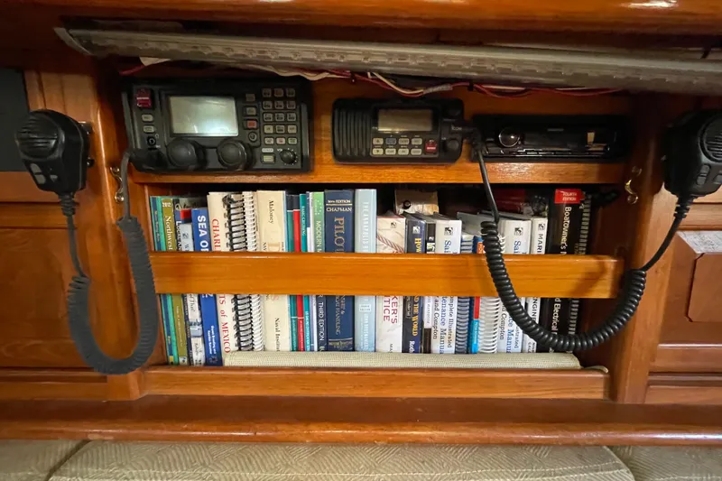 Slide: The Image of 1981 Hans Christian MKII yacht interior with navigation equipment and nautical books. - 6
