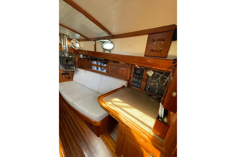 Slide: The Image of Interior of 1981 Hans Christian MKII sailboat with wooden furnishings and cozy seating area. - 7