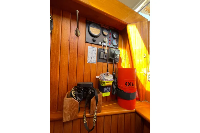 Slide: The Image of Wooden interior of 1981 Hans Christian MKII sailboat with navigation instruments and safety equipment. - 9