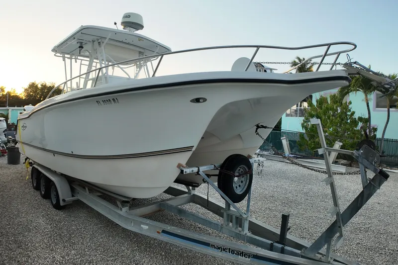 Slide: The Image of 2003 Pro Sports 2860 SC ProKat boat on trailer, parked outdoors at sunset. - 3