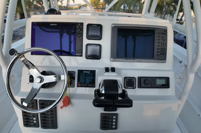 Slide: The Image of 2003 Pro Sports 2860 SC ProKat boat dashboard with steering wheel and navigation equipment. - 7