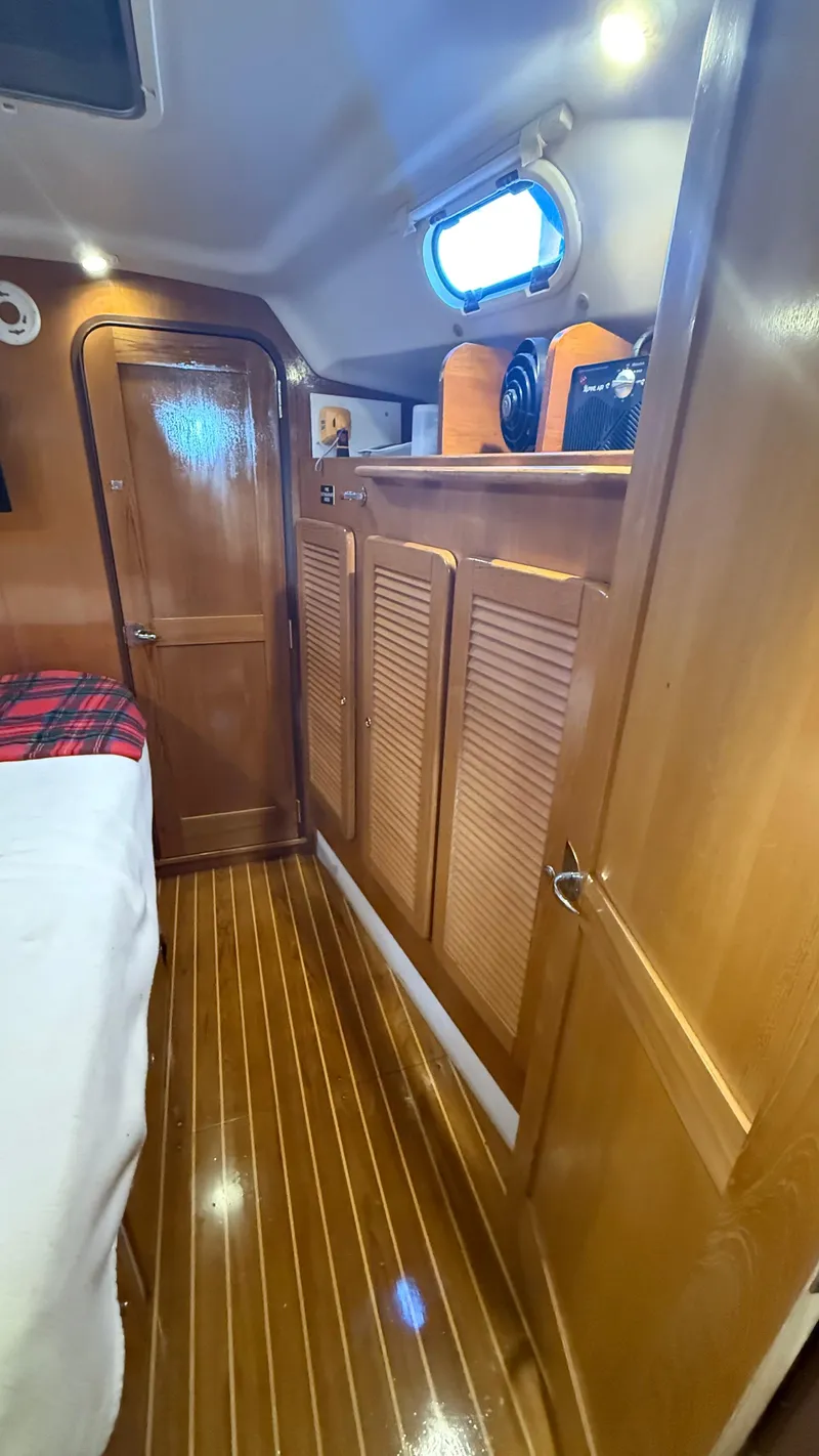 Slide: The Image of Interior of 2004 Catalina 470 yacht with wooden cabinetry and flooring. - 12