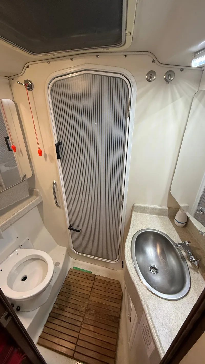 Slide: The Image of 2004 Catalina 470 yacht bathroom with shower, sink, and toilet. - 19
