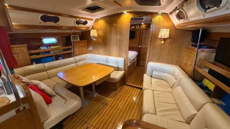 Slide: The Image of Luxurious interior of a 2004 Catalina 470 yacht with wooden finishes and comfortable seating. - 2