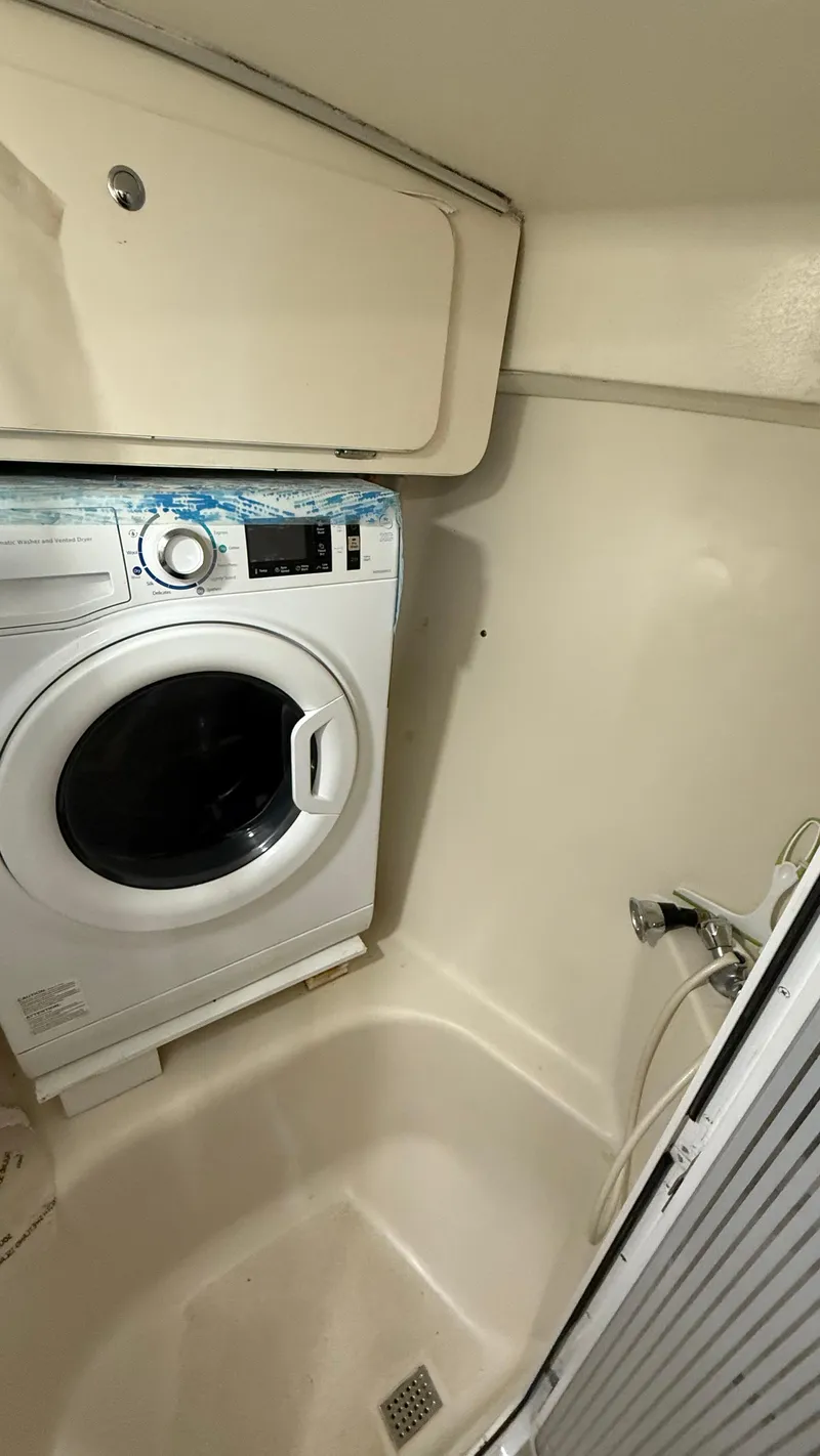 Slide: The Image of Laundry area in 2004 Catalina 470 yacht with washing machine and storage. - 20