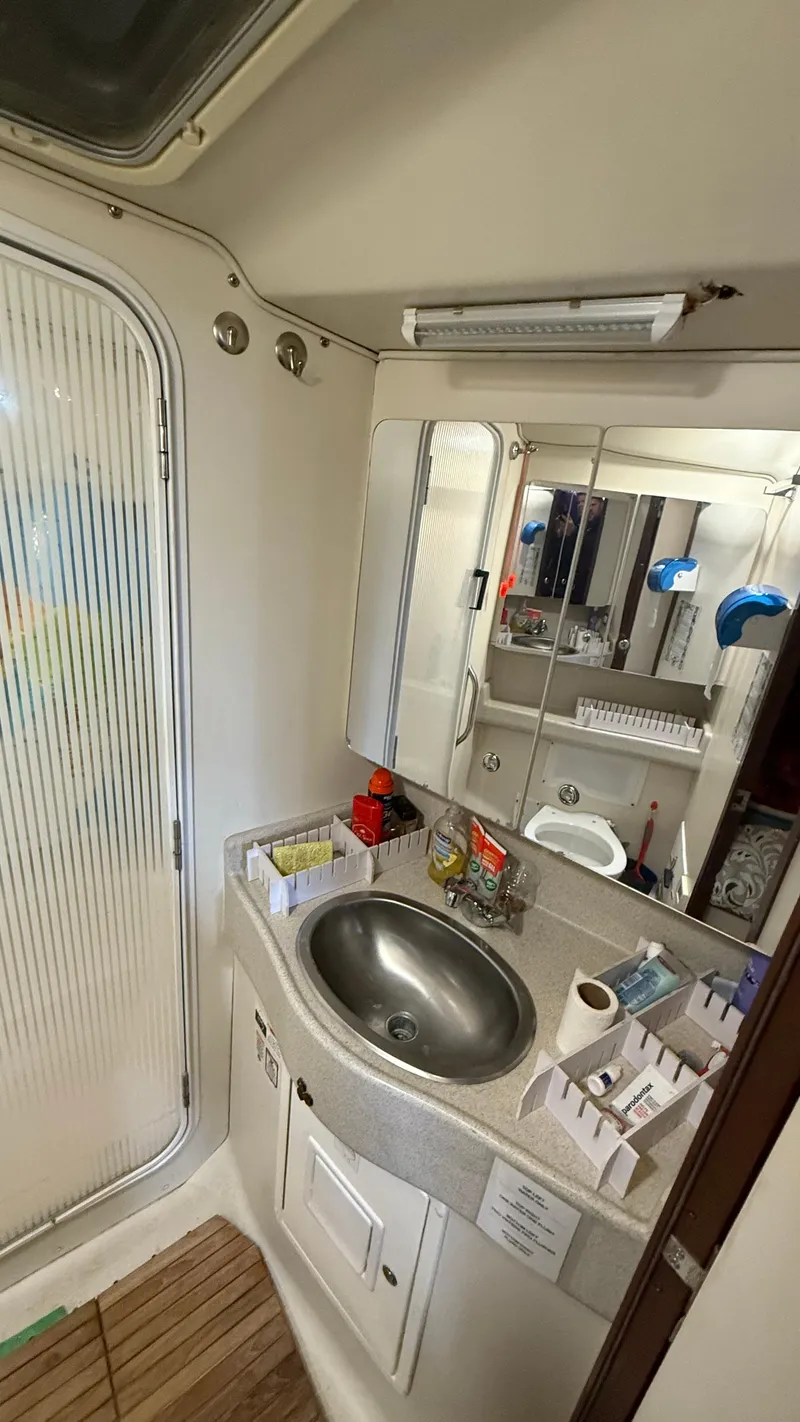 Slide: The Image of Bathroom interior of a 2004 Catalina 470 yacht with sink and mirror. - 21