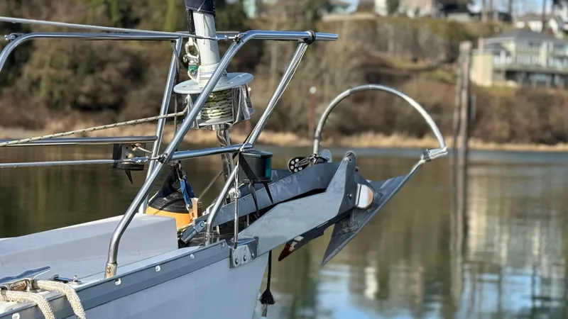 Slide: The Image of Bow of 2004 Catalina 470 sailboat with anchor and calm water background. - 27