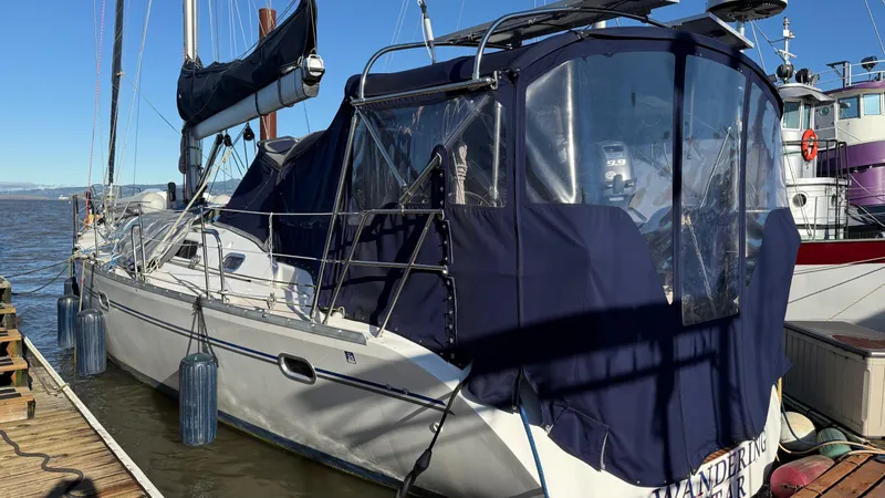 Slide: The Image of Catalina 470 sailboat, 2004 model, docked with blue canvas cover and clear windows. - 31