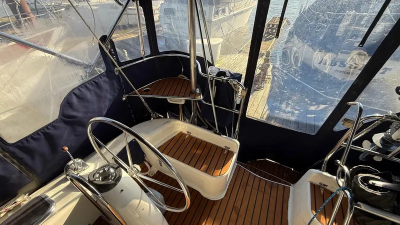Slide: The Image of 2004 Catalina 470 yacht cockpit with dual steering wheels and wooden flooring. - 33