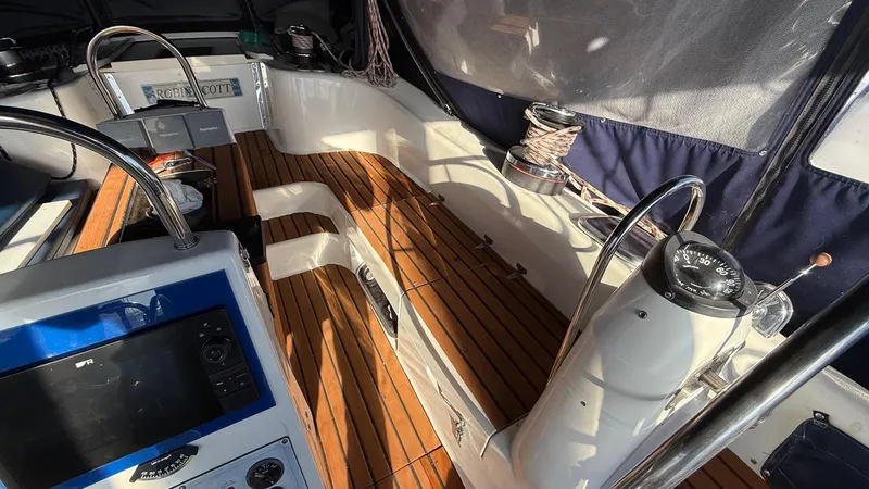 Slide: The Image of Cockpit of 2004 Catalina 470 sailboat with wooden flooring and navigation equipment. - 37
