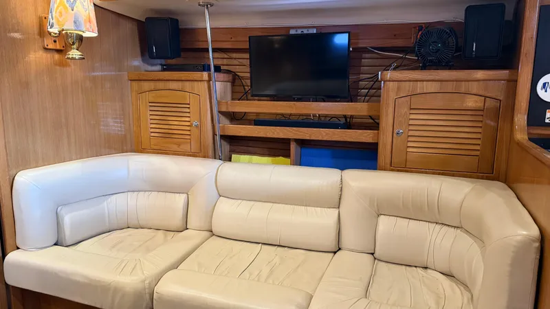Slide: The Image of Luxurious interior of 2004 Catalina 470 yacht with cream leather seating and wooden cabinetry. - 4