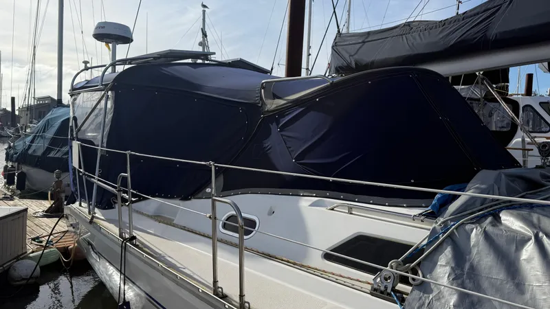 Slide: The Image of 2004 Catalina 470 sailboat docked with blue canvas cover. - 40