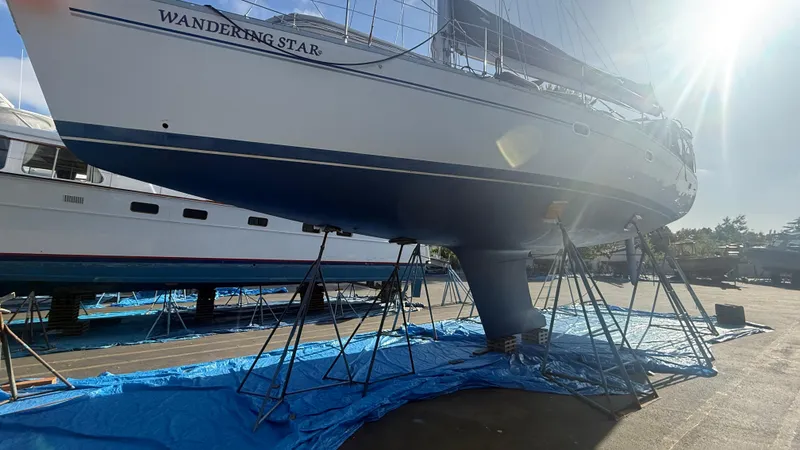 Slide: The Image of Catalina 470 sailboat "Wandering Star" on stands, sunlit, 2004 model, in a boatyard. - 41