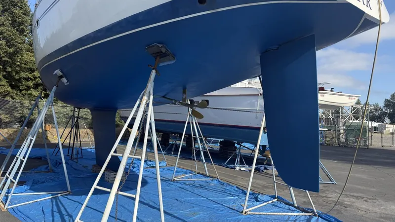 Slide: The Image of 2004 Catalina 470 sailboat on stands, blue hull, outdoor storage. - 44