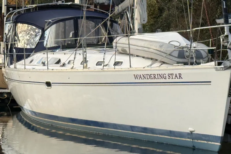 Slide: The Image of 2004 Catalina 470 sailboat named "Wandering Star" docked in a marina. - 55