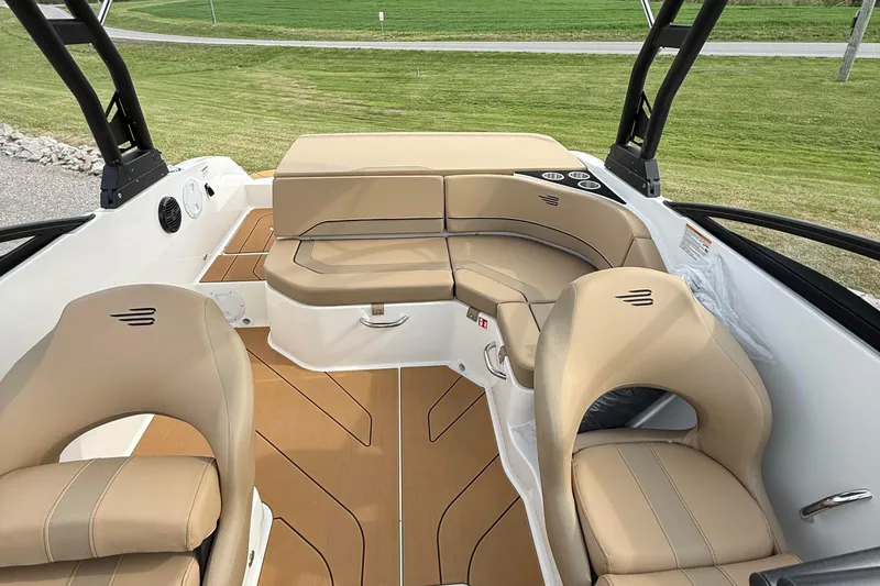 Slide: The Image of 2026 Bayliner V20i boat interior with beige seating and sleek design. - 10