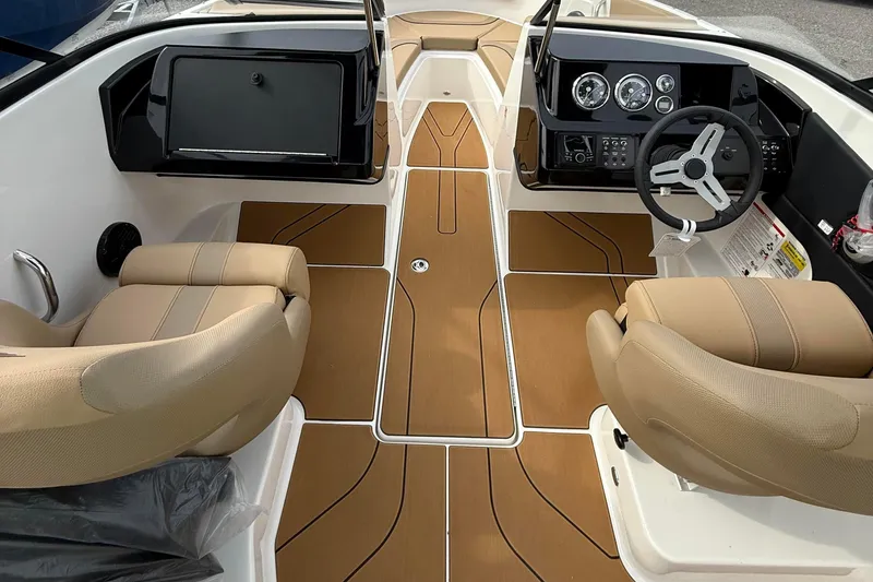 Slide: The Image of 2026 Bayliner V20i boat interior with tan seats and modern dashboard design. - 6