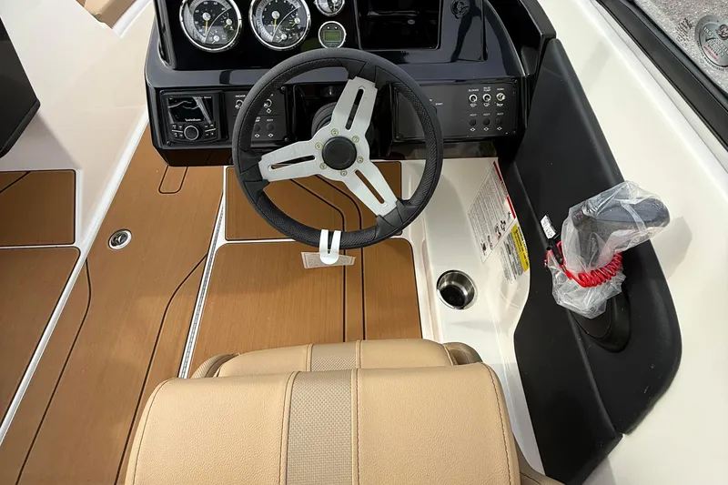 Slide: The Image of 2026 Bayliner V20i boat cockpit with steering wheel and control panel. - 7