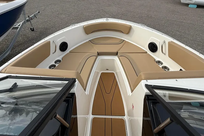 Slide: The Image of 2026 Bayliner V20i boat interior with tan seating and cup holders. - 8
