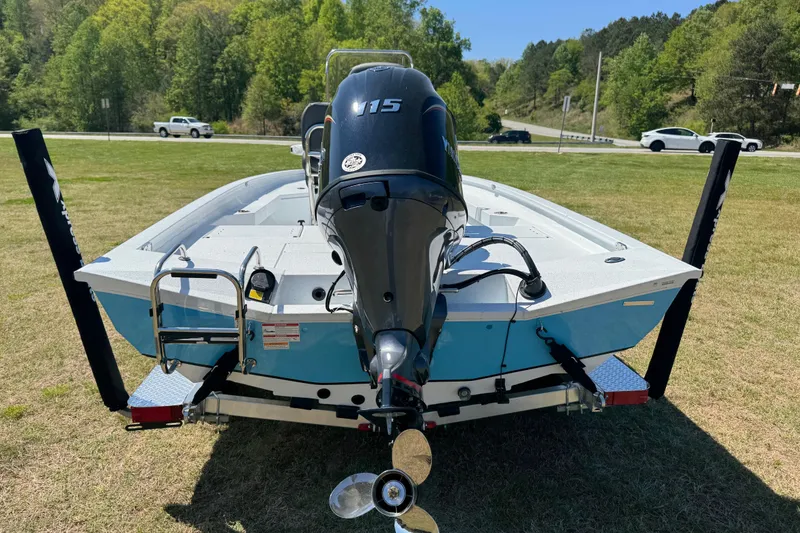 Slide: The Image of 2026 Xpress H20B Bay boat with outboard motor on grassy area. - 10