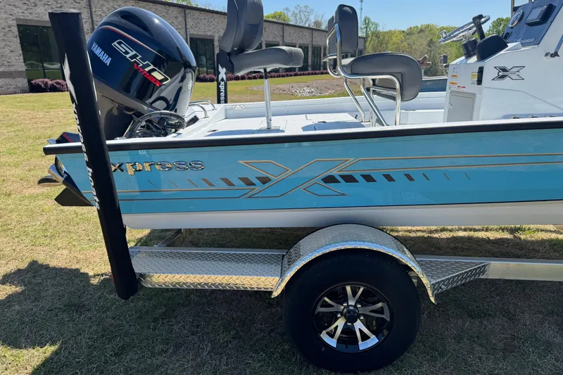 Slide: The Image of 2026 Xpress H20B Bay boat with Yamaha engine on a trailer, parked outdoors. - 12