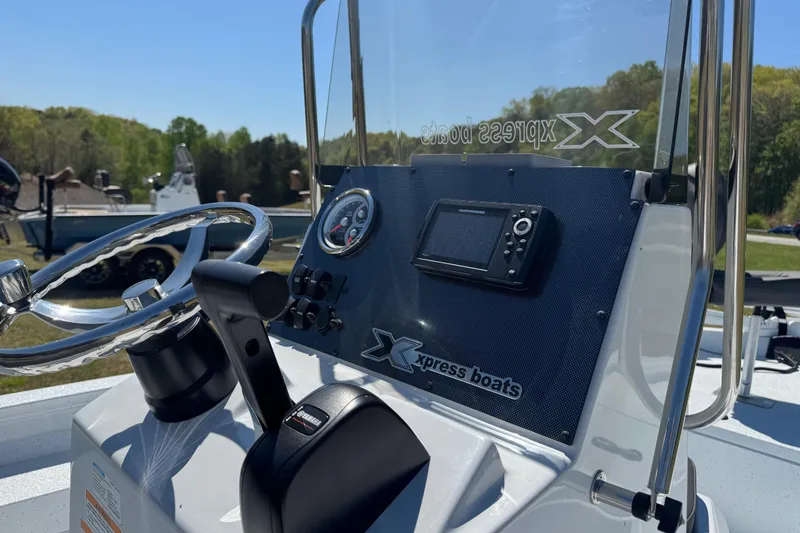 Slide: The Image of 2026 Xpress H20B Bay boat dashboard with steering wheel and navigation system. - 13