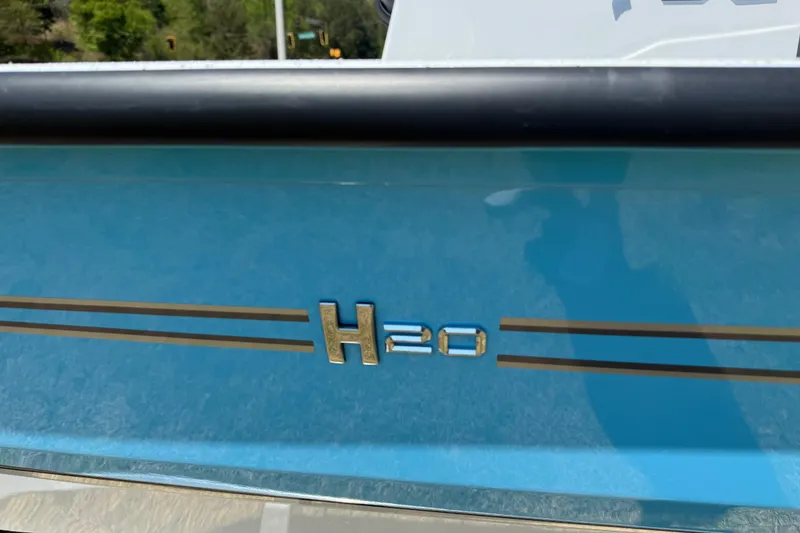 Slide: The Image of 2026 Xpress H20B Bay boat with sleek blue design and logo detail. - 5
