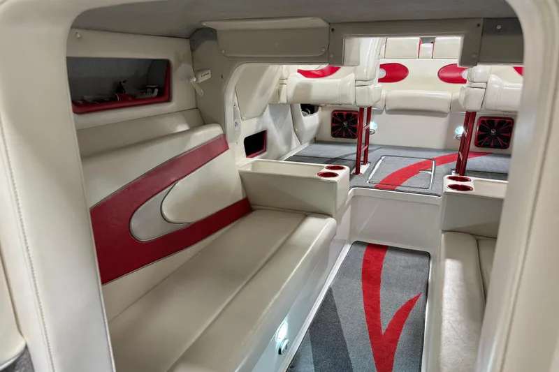 Slide: The Image of Luxurious interior of a 2004 Sleekcraft Enforcer 30 boat with red and white seating. - 12