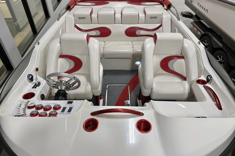 Slide: The Image of 2004 Sleekcraft Enforcer 30 boat interior with red and white seating and control panel. - 13