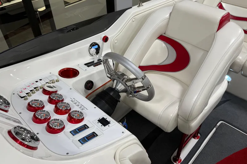 Slide: The Image of Interior of 2004 Sleekcraft Enforcer 30 boat with white and red seating, modern dashboard. - 14