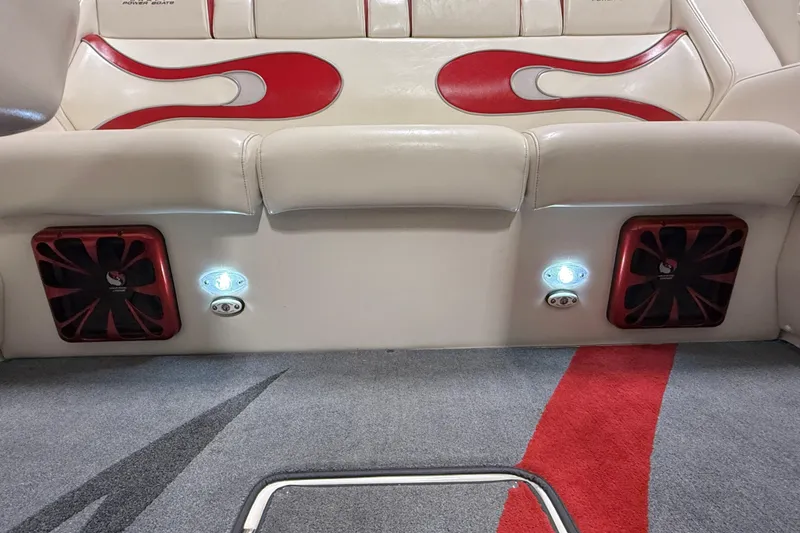 Slide: The Image of Interior of 2004 Sleekcraft Enforcer 30 with red and white seating, speakers, and carpet design. - 16