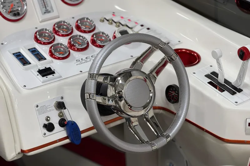 Slide: The Image of Interior of a 2004 Sleekcraft Enforcer 30 boat with white and red seating. - 22